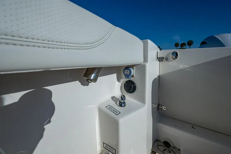 @c Yacht Photos Pics 2022 Pursuit S 268 Sport boat interior detail with controls and seating.