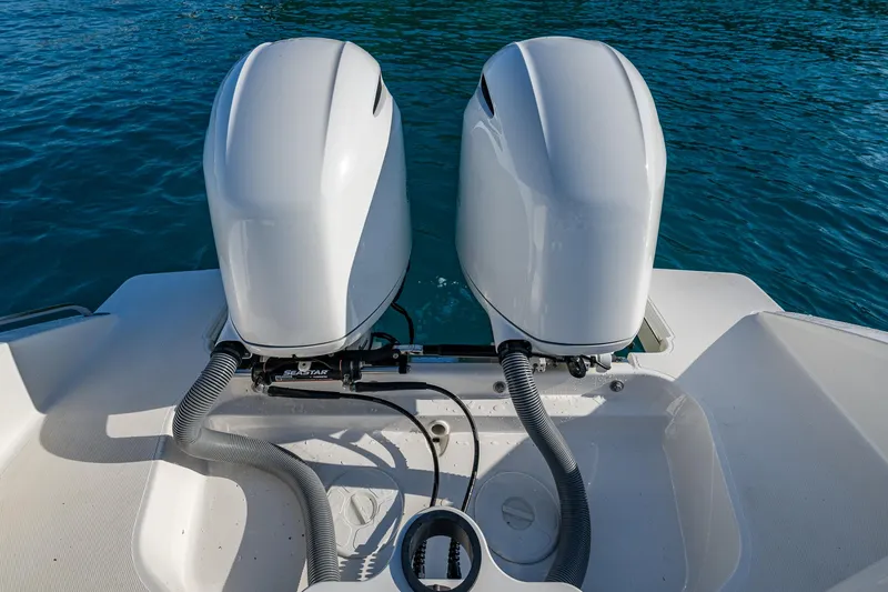 @c Yacht Photos Pics Twin outboard motors on a 2022 Pursuit S 268 Sport boat in clear blue water.
