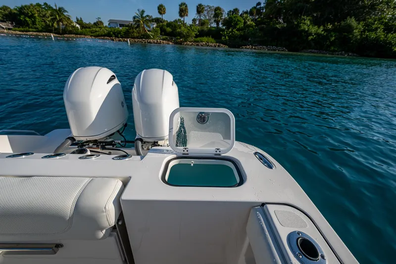 @c Yacht Photos Pics 2022 Pursuit S 268 Sport boat with dual engines on a serene blue water backdrop.