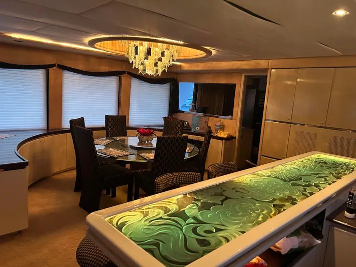Entrepeneur Yacht Photos Pics Luxurious interior of a 1992 Christensen motor yacht with elegant dining area and chandelier.