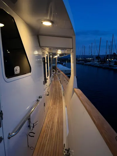 Entrepeneur Yacht Photos Pics Side deck of 1992 Christensen motor yacht at dusk, docked in marina.