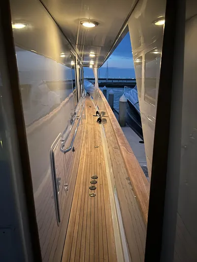 Entrepeneur Yacht Photos Pics Sleek 1992 Christensen motor yacht deck with wooden flooring and modern lighting at dusk.