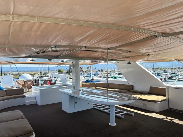 Entrepeneur Yacht Photos Pics Luxurious 1992 Christensen motor yacht deck with seating, table, and marina view.
