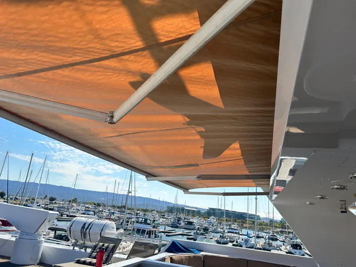 Entrepeneur Yacht Photos Pics 1992 Christensen motor yacht with sunshade, docked at a marina under clear skies.