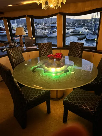 Entrepeneur Yacht Photos Pics Luxurious dining area on a 1992 Christensen motor yacht with elegant decor and marina view.