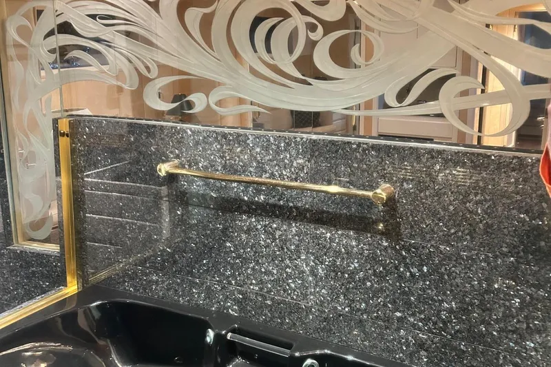 Entrepeneur Yacht Photos Pics Luxurious bathroom interior on a 1992 Christensen motor yacht with ornate mirror and granite surfaces.