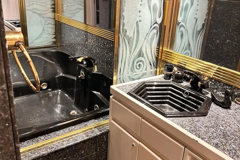 Entrepeneur Yacht Photos Pics Luxurious bathroom with black fixtures on a 1992 Christensen motor yacht.