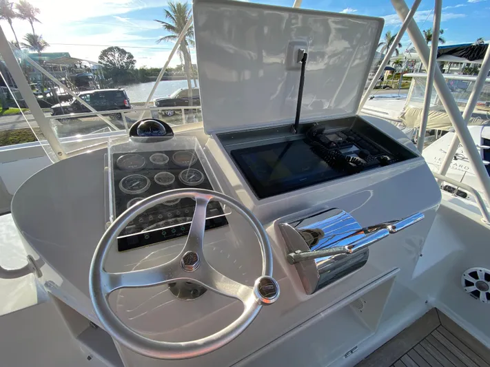  Yacht Photos Pics Helm of 1995 Mares 58 Power Cat with steering wheel and control panel.