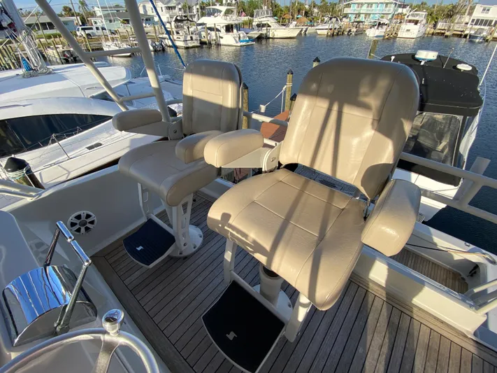  Yacht Photos Pics Two beige captain chairs on a 1995 Mares 58 Power Cat, docked at a marina.