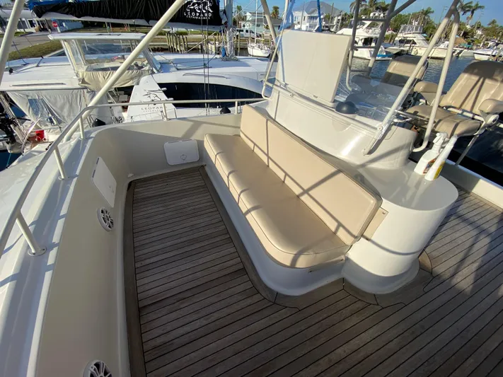  Yacht Photos Pics Mares 58 Power Cat 1995 boat deck with cushioned seating and wooden flooring.