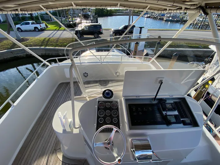  Yacht Photos Pics 1995 Mares 58 Power Cat helm with steering wheel, gauges, and waterfront view.