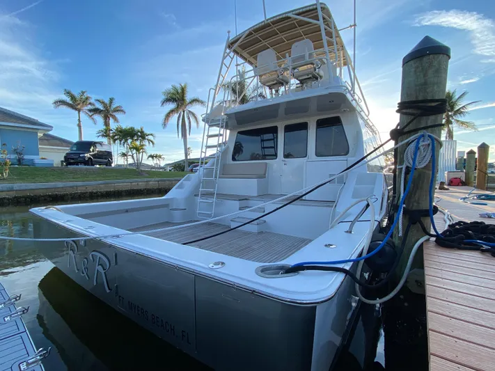  Yacht Photos Pics 1995 Mares 58 Power Cat docked, featuring spacious deck and flybridge, with palm trees in background.