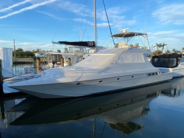  Yacht Photos Pics 1995 Mares 58 Power Cat yacht docked in a marina under a clear blue sky.