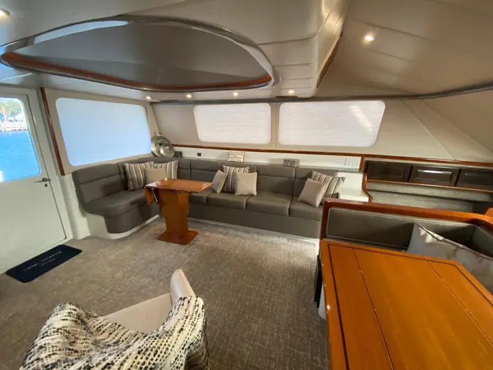  Yacht Photos Pics Spacious interior of 1995 Mares 58 Power Cat with modern seating and wooden accents.