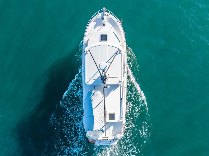 Naukati II Yacht Photos Pics Aerial view of 2000 Nordic Tug 32 cruising on turquoise water.