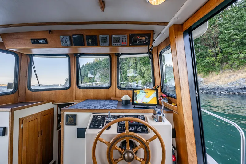 Naukati II Yacht Photos Pics Interior of a 2000 Nordic Tug 32 boat with wooden helm and navigation equipment.