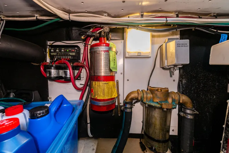 Naukati II Yacht Photos Pics Engine room of a 2000 Nordic Tug 32 with fire extinguisher and electrical components.