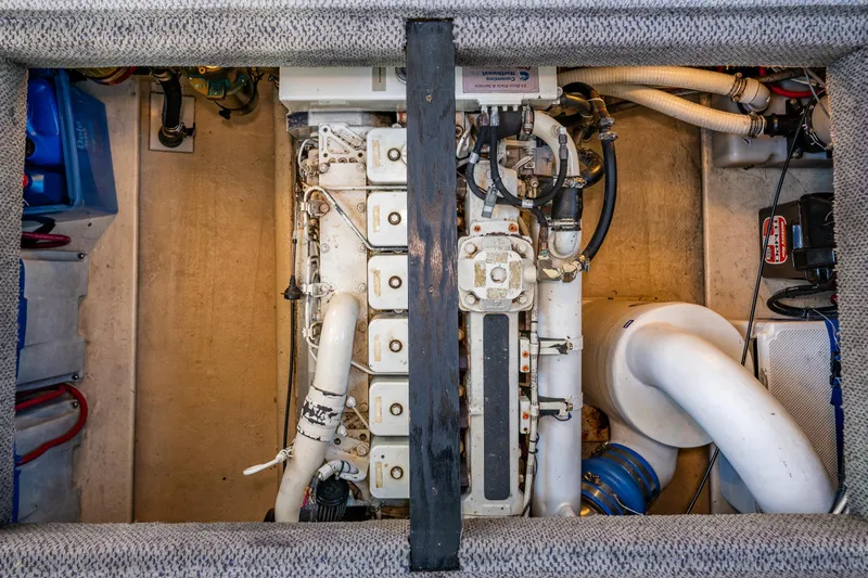 Naukati II Yacht Photos Pics Engine compartment of a 2000 Nordic Tug 32, showcasing mechanical components and piping.