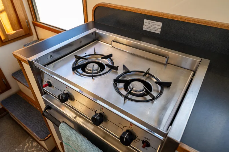 Naukati II Yacht Photos Pics Stainless steel stove in 2000 Nordic Tug 32 boat kitchen interior.