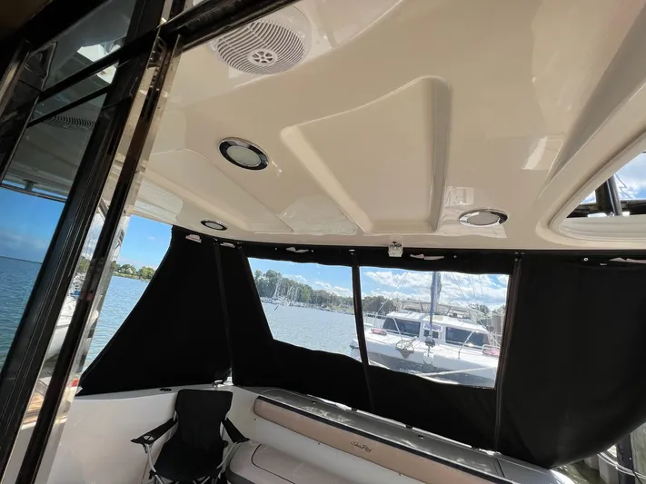  Yacht Photos Pics Interior view of a 2005 Sea Ray 500 Sedan Bridge yacht with black curtains and seating.