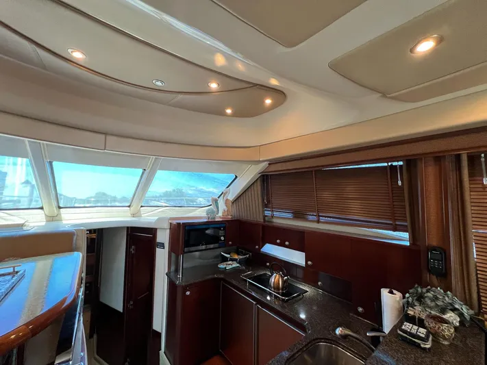  Yacht Photos Pics Interior of 2005 Sea Ray 500 Sedan Bridge yacht, featuring a modern kitchen area.