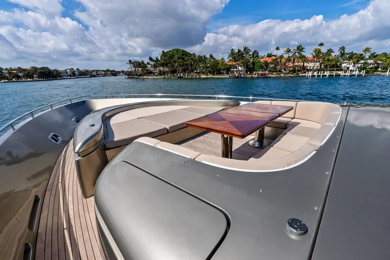 Diamond Yacht Photos Pics Luxurious 2013 AB 116 Motoryacht deck with elegant seating and table, overlooking scenic waterfront.