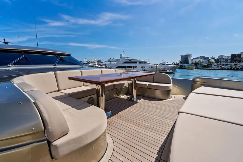 Diamond Yacht Photos Pics Luxurious 2013 AB 116 Motoryacht deck with elegant seating and table, docked in a marina.