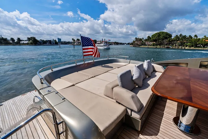 Diamond Yacht Photos Pics Luxurious 2013 AB 116 Motoryacht deck with sun loungers and dining table, overlooking scenic waterway.