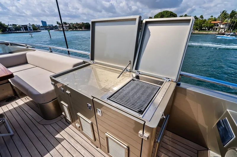 Diamond Yacht Photos Pics Outdoor kitchen on 2013 AB 116 Motoryacht with grill and seating, overlooking water.