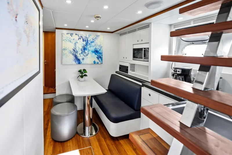 Diamond Yacht Photos Pics Luxurious interior of 2013 AB 116 Motoryacht with modern dining area and staircase.