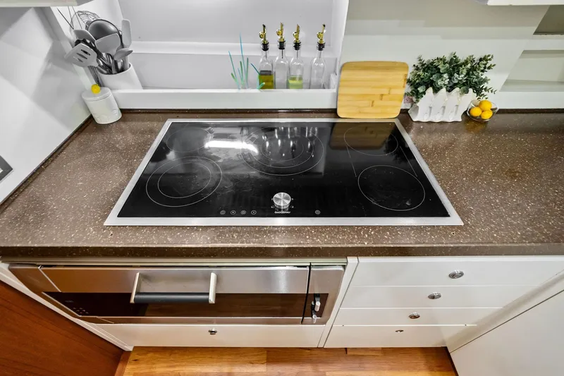 Diamond Yacht Photos Pics Modern kitchen on 2013 AB 116 Motoryacht with sleek stovetop and countertop accessories.