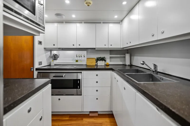 Diamond Yacht Photos Pics Modern kitchen in 2013 AB 116 Motoryacht with sleek white cabinetry and stainless steel appliances.