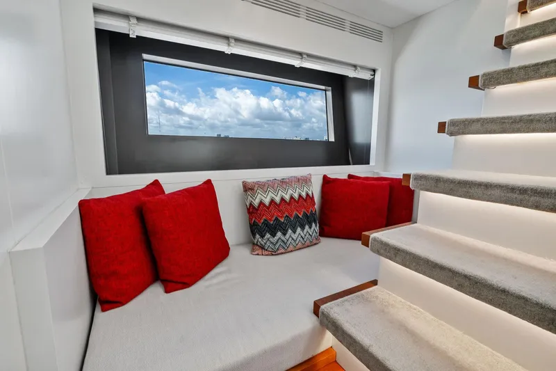 Diamond Yacht Photos Pics Luxurious 2013 AB 116 Motoryacht interior with cozy seating, red cushions, and scenic window view.