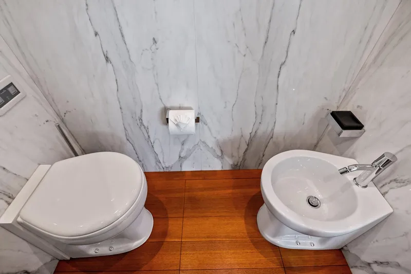 Diamond Yacht Photos Pics Luxurious bathroom on 2013 AB 116 Motoryacht with marble walls and wooden flooring.