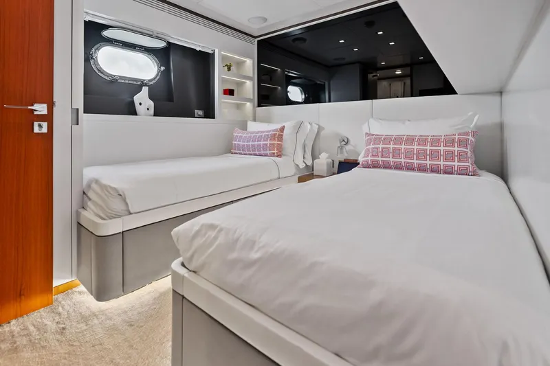 Diamond Yacht Photos Pics Luxurious twin bedroom on 2013 AB 116 Motoryacht with modern decor and porthole window.