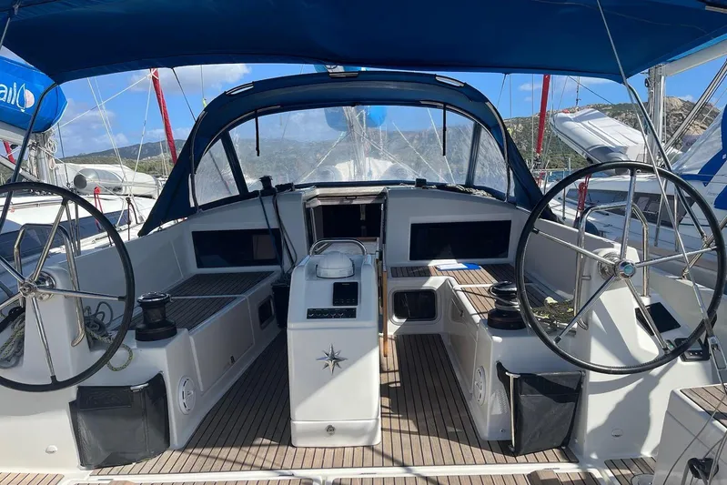 Cicerenella Yacht Photos Pics 2019 Jeanneau Sun Odyssey 440 sailboat cockpit with dual steering wheels and blue canopy.