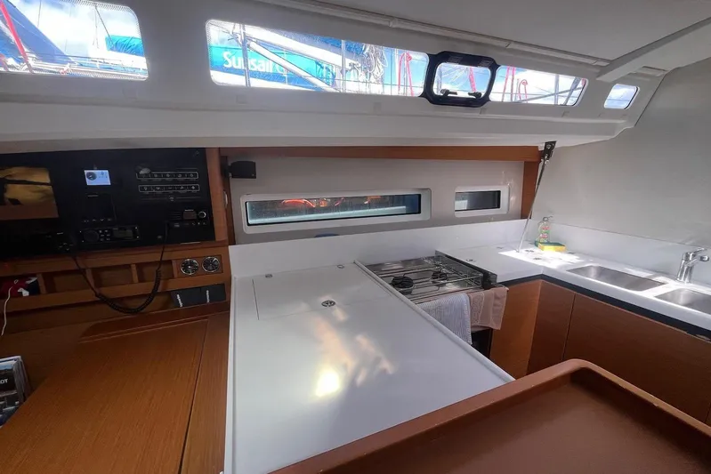 Cicerenella Yacht Photos Pics Interior of 2019 Jeanneau Sun Odyssey 440 yacht, featuring modern kitchen and navigation controls.