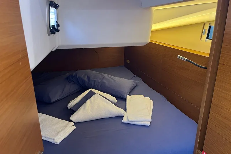 Cicerenella Yacht Photos Pics Cozy cabin interior of 2019 Jeanneau Sun Odyssey 440 yacht with neatly arranged bedding.