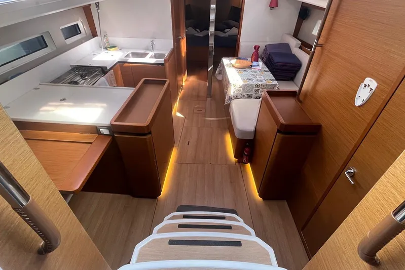Cicerenella Yacht Photos Pics Interior of 2019 Jeanneau Sun Odyssey 440 yacht, featuring modern kitchen and dining area.