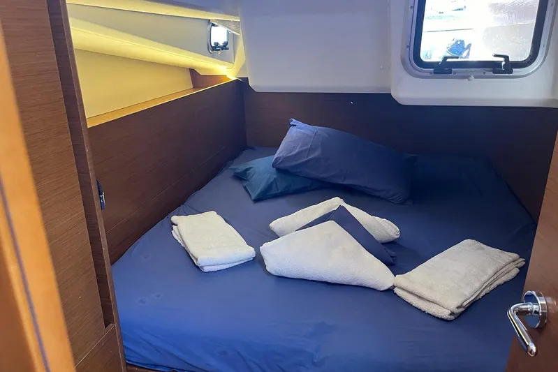 Cicerenella Yacht Photos Pics Cozy cabin interior of 2019 Jeanneau Sun Odyssey 440 with neatly arranged bedding.