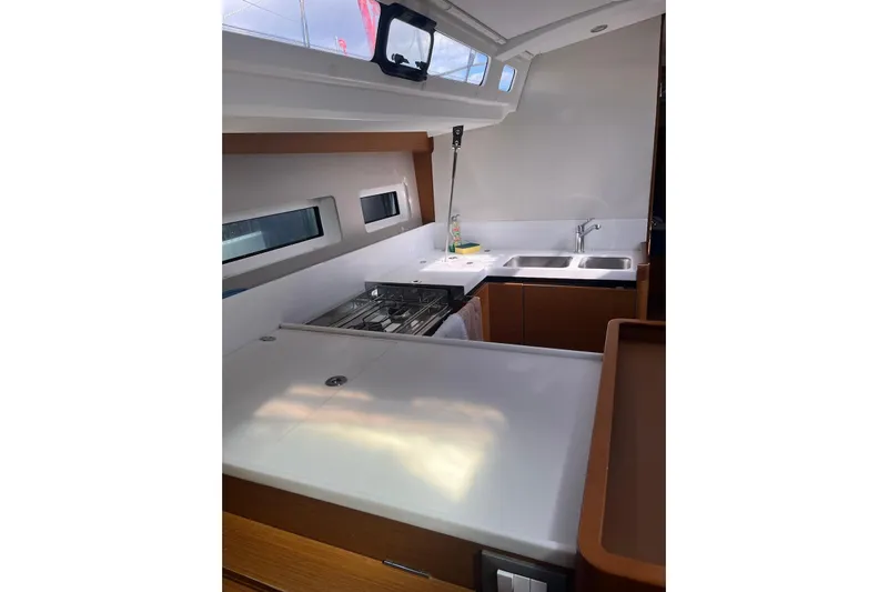 Cicerenella Yacht Photos Pics Modern kitchen interior of 2019 Jeanneau Sun Odyssey 440 yacht with stove and sink.