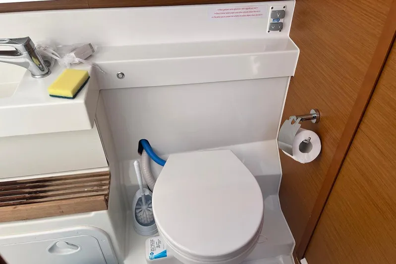Cicerenella Yacht Photos Pics Bathroom interior of 2019 Jeanneau Sun Odyssey 440 yacht with toilet and sink.