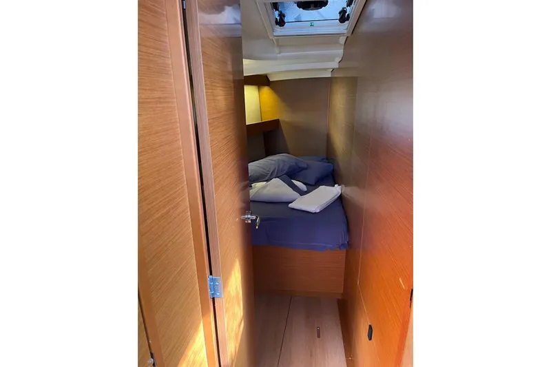 Cicerenella Yacht Photos Pics Cozy cabin interior of 2019 Jeanneau Sun Odyssey 440 sailboat with bed and wooden finish.