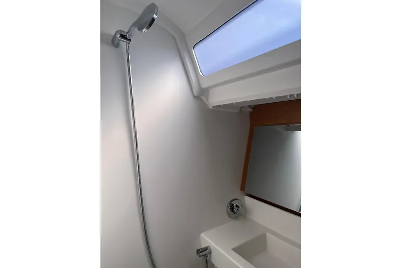 Cicerenella Yacht Photos Pics Bathroom interior of 2019 Jeanneau Sun Odyssey 440 yacht, featuring shower and sink.