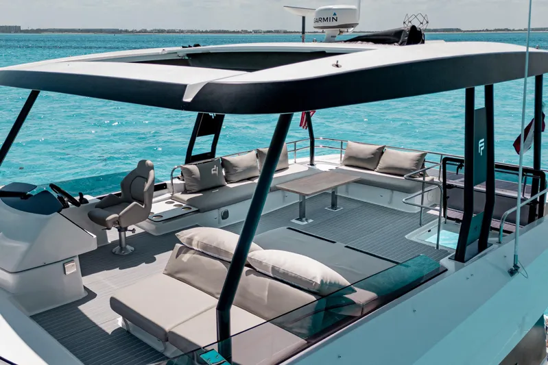 Libert'e Yacht Photos Pics Luxurious 2020 Fountaine Pajot MY6 yacht with spacious deck and seating, cruising on turquoise waters.