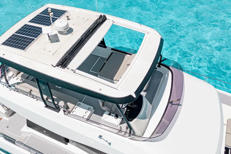 Libert'e Yacht Photos Pics 2020 Fountaine Pajot MY6 yacht with solar panels, cruising in clear turquoise waters.