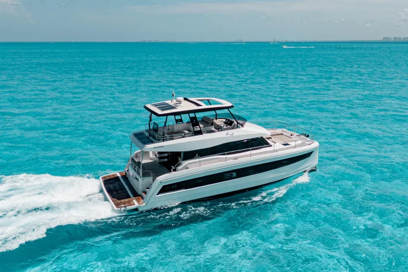 Libert'e Yacht Photos Pics 2020 Fountaine Pajot MY6 yacht cruising on clear blue ocean waters.