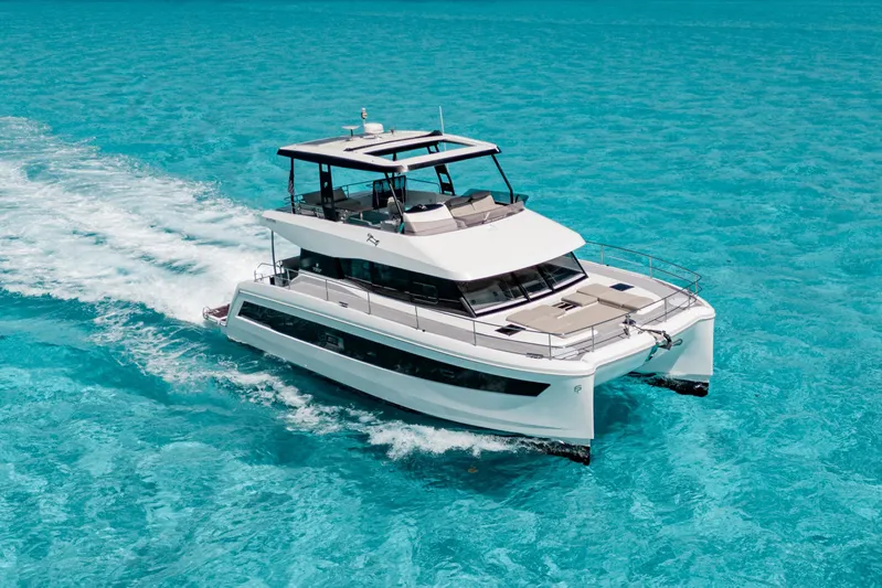Libert'e Yacht Photos Pics 2020 Fountaine Pajot MY6 yacht cruising on clear turquoise waters.