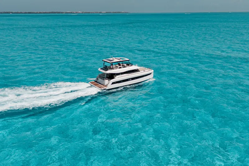 Libert'e Yacht Photos Pics 2020 Fountaine Pajot MY6 yacht cruising on clear turquoise waters.