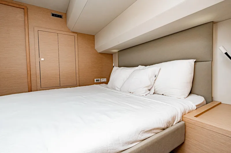 Libert'e Yacht Photos Pics Luxurious bedroom interior of 2020 Fountaine Pajot MY6 yacht with modern design.
